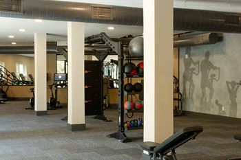 A gym with a variety of equipment including weights and exercise machines.
